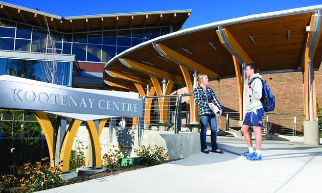 Two students standing at the College of the Rockies entrance