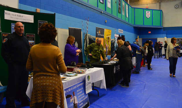 job fair booths with people in front of them