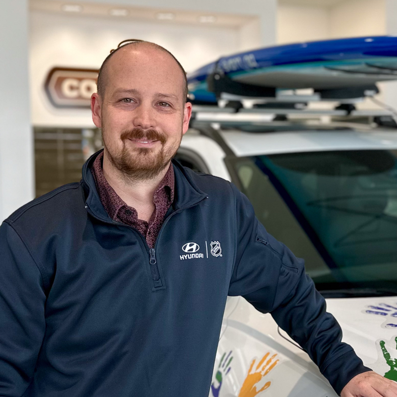 Dave Moodie standing in front of a white vehicle