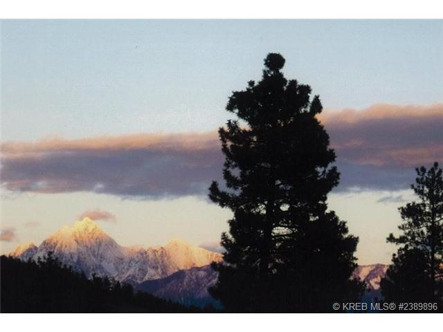 Mt. Fisher surrounded by pink clouds at sunset. 