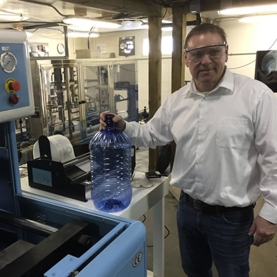 Owner Murray Floyd demonstrates Culligan new bottling facility and announces major expansion of his companies.