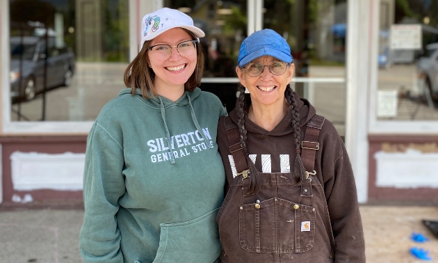 Danika and a family member standing together wearing company hoodies