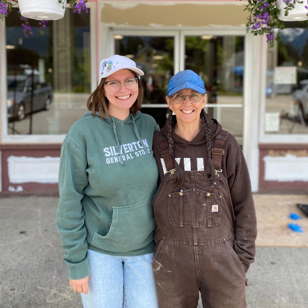 Danika and a family member standing together wearing company hoodies