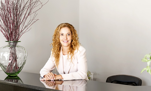 A smiling receptionist at an office.