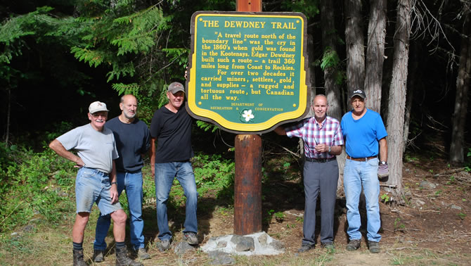Picture of the Dewdney Trail Heritage Society members with a newly restored sign. 