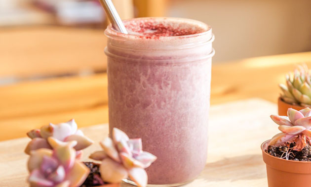 A pink-coloured elixir called Flower fills a glass jar.