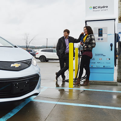 A Chevy Bolt is parked next to the newly unveiled DC fast-charging station in Cranbrook, B.C.