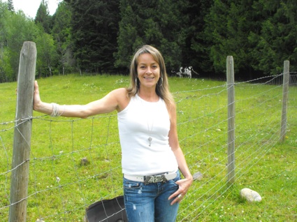 Woman standing by fence