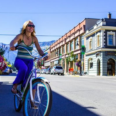 Girl on bike riding in downtown Fernie. 