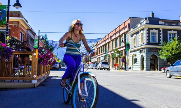 Girl on bike riding in downtown Fernie. 