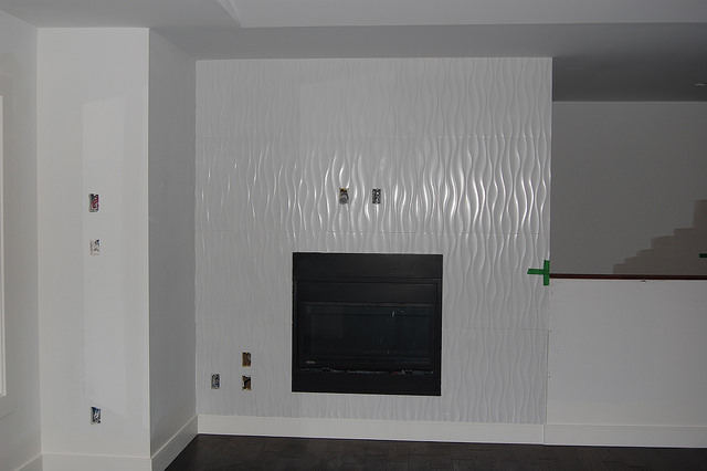 An example of a white contempary fireplace inset into a wall. 