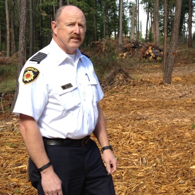 Kimberley Fire Chief Al Collinson is standing on tree chips from a fuel reduction project at Duck Pond.