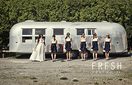 bridal party standing in front of a trailer