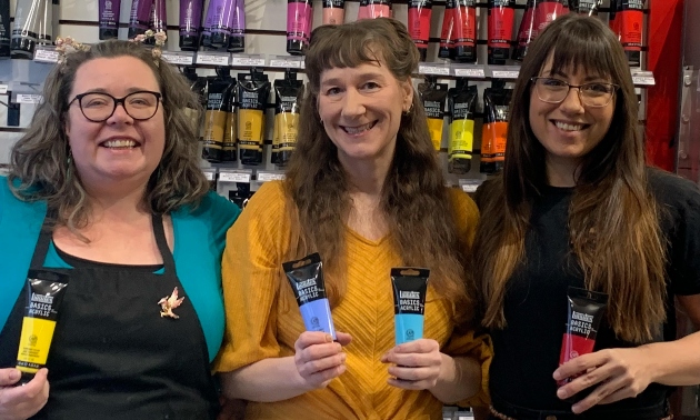 Three owners of Funk Haus Craft Lab holding art supplies