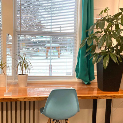 Picture of wooden desk with view of snowy scene outside window. 