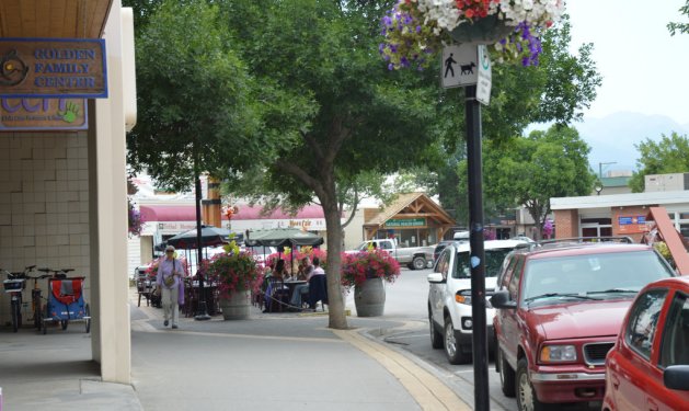 Flags and timberframe gateposts mark the entrance to Golden, B.C.