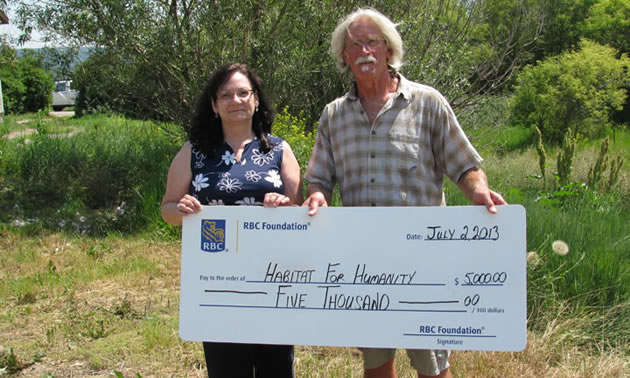 Earlier this year Maureen Foxworthy of RBC presents a cheque to Gord Johnson of Habitat for Humanity Cranbrook Project