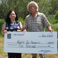 Earlier this year Maureen Foxworthy of RBC presents a cheque to Gord Johnson of Habitat for Humanity Cranbrook Project