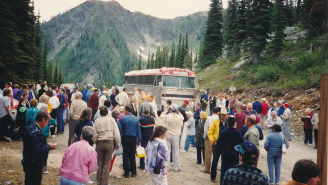 Large group of people in front of a bus