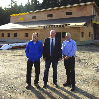 Alan Mason, Mark McKee and Daniel Kellie in front of new greeting centre for snowmobilers. 