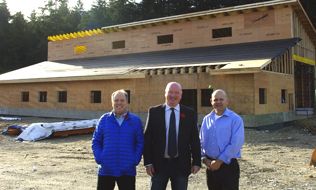 Alan Mason, Mark McKee and Daniel Kellie in front of new greeting centre for snowmobilers. 