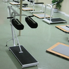 Photo of the inside of a gym, complete with exercise equipment. 