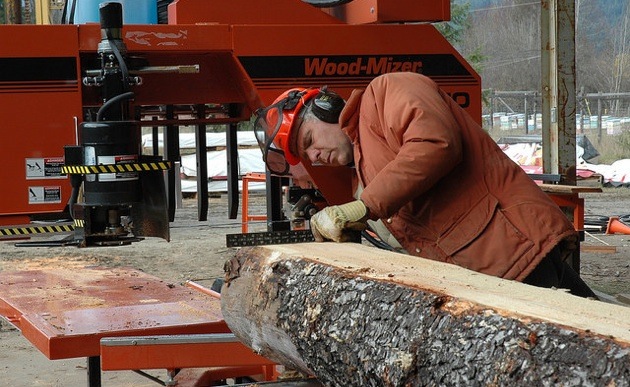 Head sawyer David Strom works on the Woodmizer sawmill of the Harrop-Procter Community Co-operative