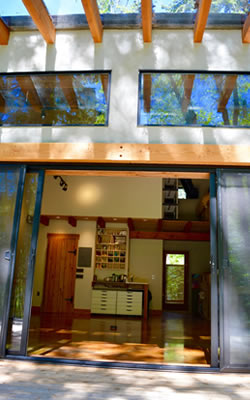 The interior of the studio with lots of windows and wood components