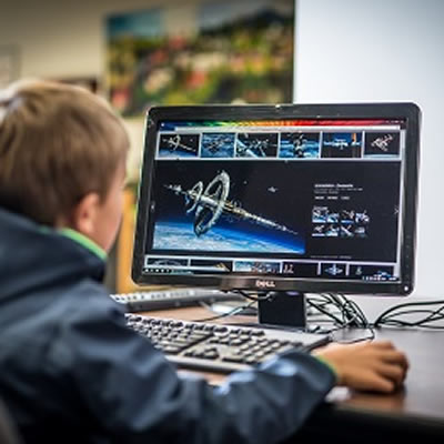 Picture of young boy using a computer. 