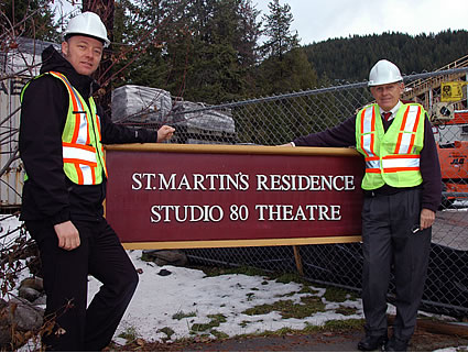 Two men standing beside  the Street residence and Studio 80 sign