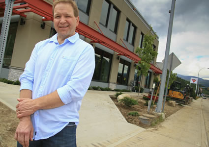 Photo of Dave Streloff standing in front of a newly constructed building