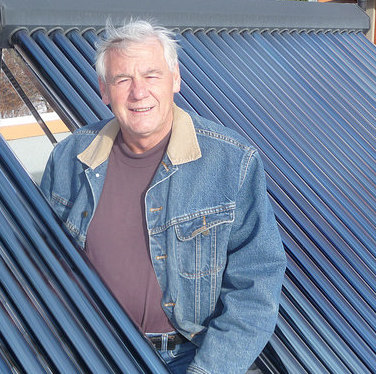 Jori Adank on the roof of his net zero energy (NZE) home in Kimberley, B.C.