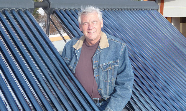 Jori Adank on the roof of his net zero energy (NZE) home in Kimberley, B.C.