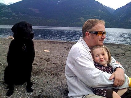 Chris Holland with his daughter and dog at the beach