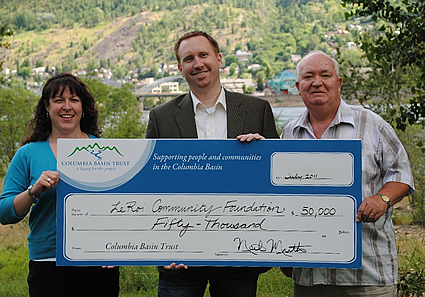 Photo of three people holding a novelty cheque