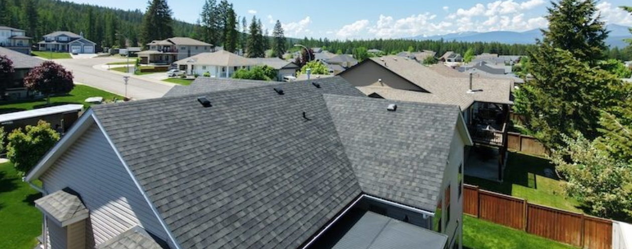 Aerial view of a home with grey asphalt shingle roofing