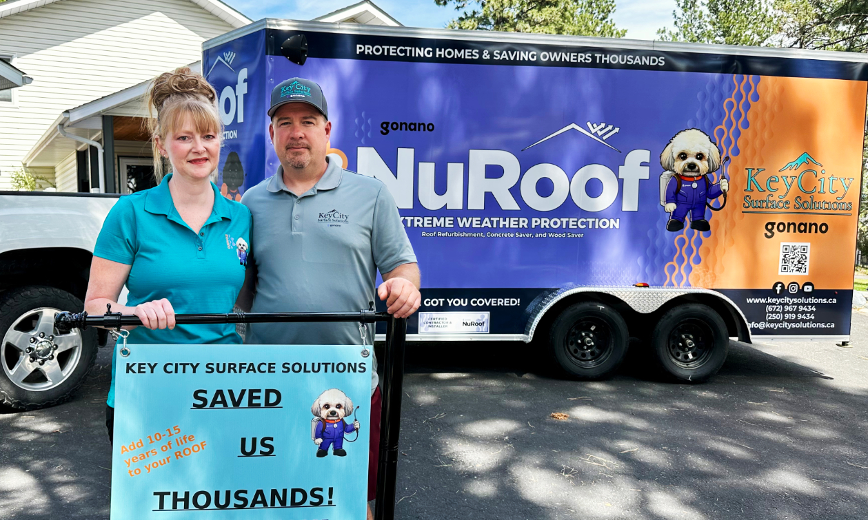 Jeff and Crystal Dyck standing in front of the NuRoof truck holding a sign that says Key City Surface Solutions saved us thousands.