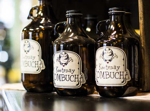 Kootenay Kombucha's unique growler and keg program allows customers to buy bottles like these, pictured in Nelson's Ellison's Cafe, and then refill them indefinitely, cutting down on packaging waste. 