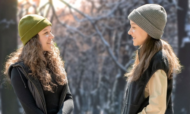 two women wearing toques