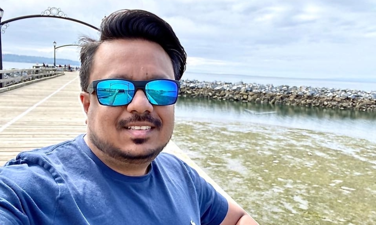 Kushal Patel at a pier wearing sunglasses