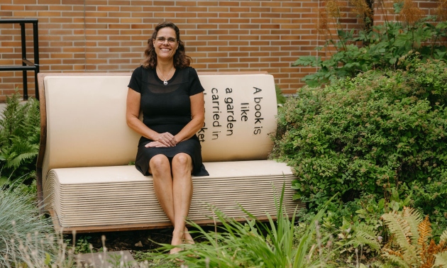 Ursula Brigl on a bench outside the Cranbrook library