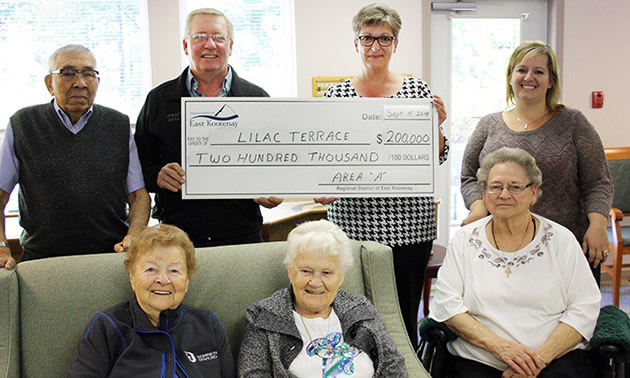 A group of people holding a cheque 