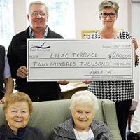 A group of people holding a cheque 