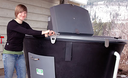 girl working with a compost bin