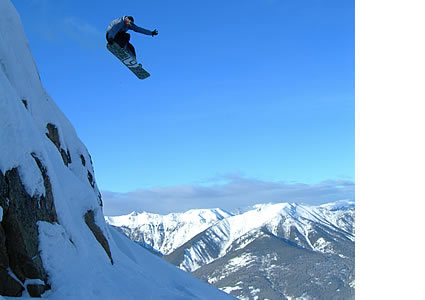 Photo of a person taking a jump on skiis