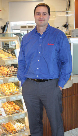 Mark Nelson standing next to the counter in the new Tim Hortons in Sparwood, B.C. 