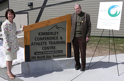 Photo of two people standing next to the Kimberley Conference and Athlete Training sign