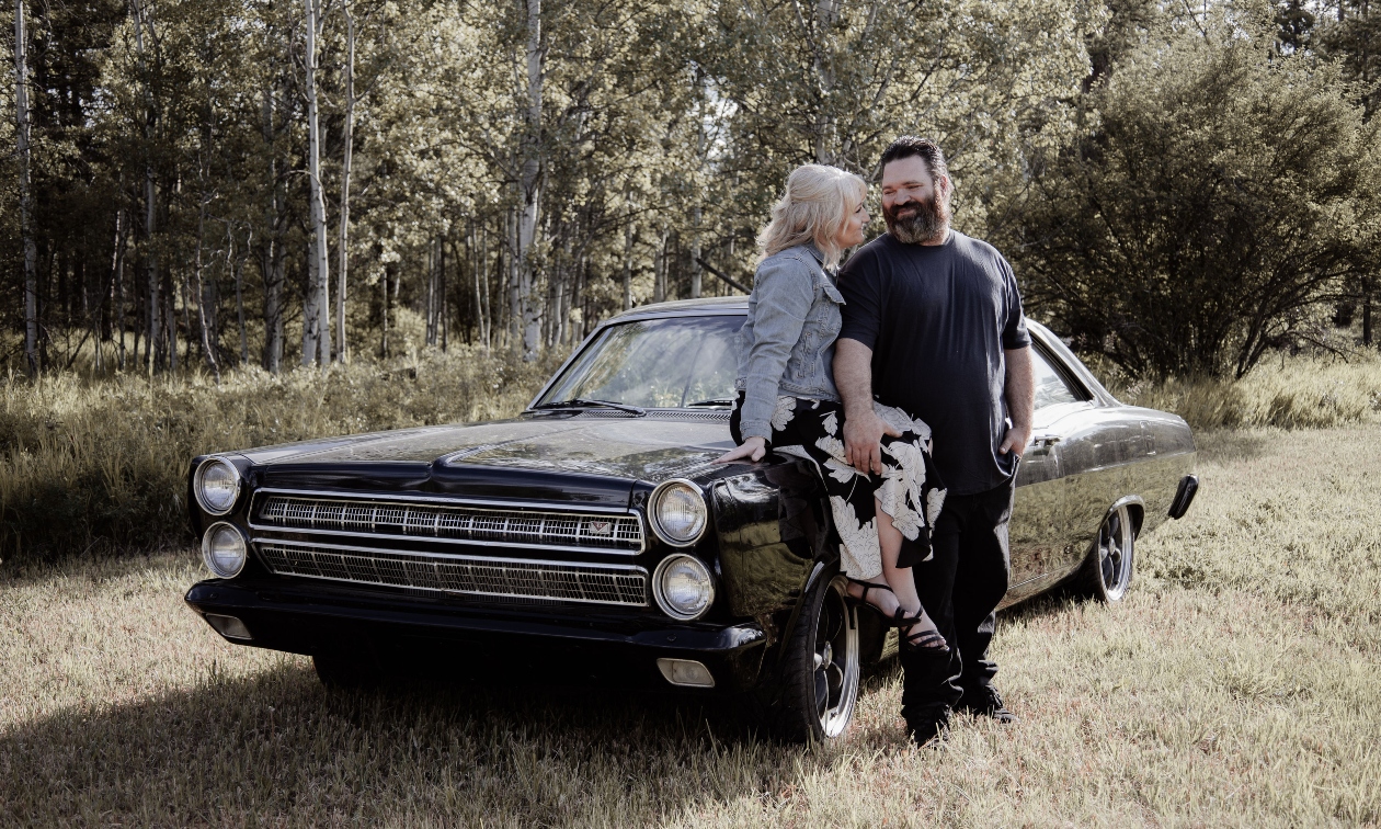 Cara and Steve Campen with a classic car