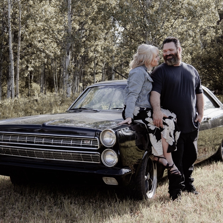 Cara and Steve Campen with a classic car