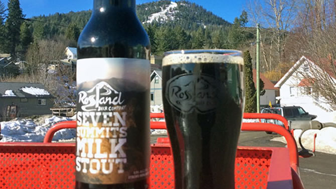 Picture of bottle and full glass of 7 Summits Milk Stout. 